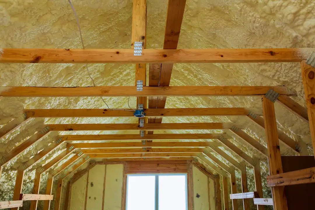 Spray foam insulation installed in a framed building assembly