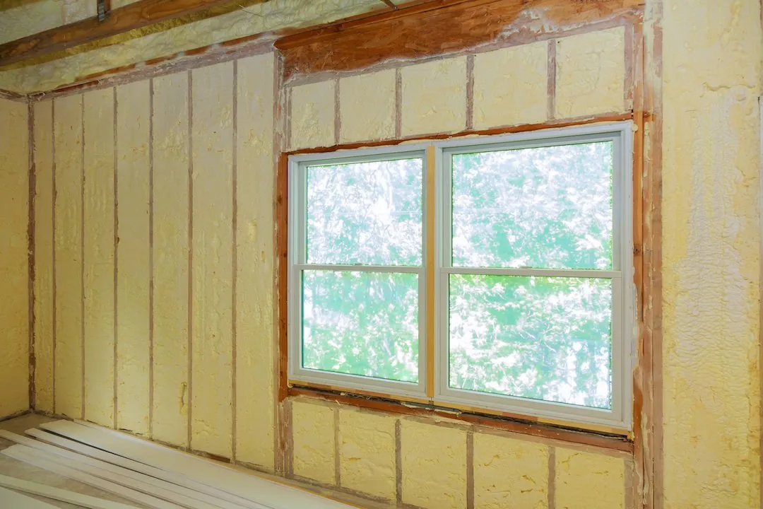 Spray foam application in a specialty building assembly